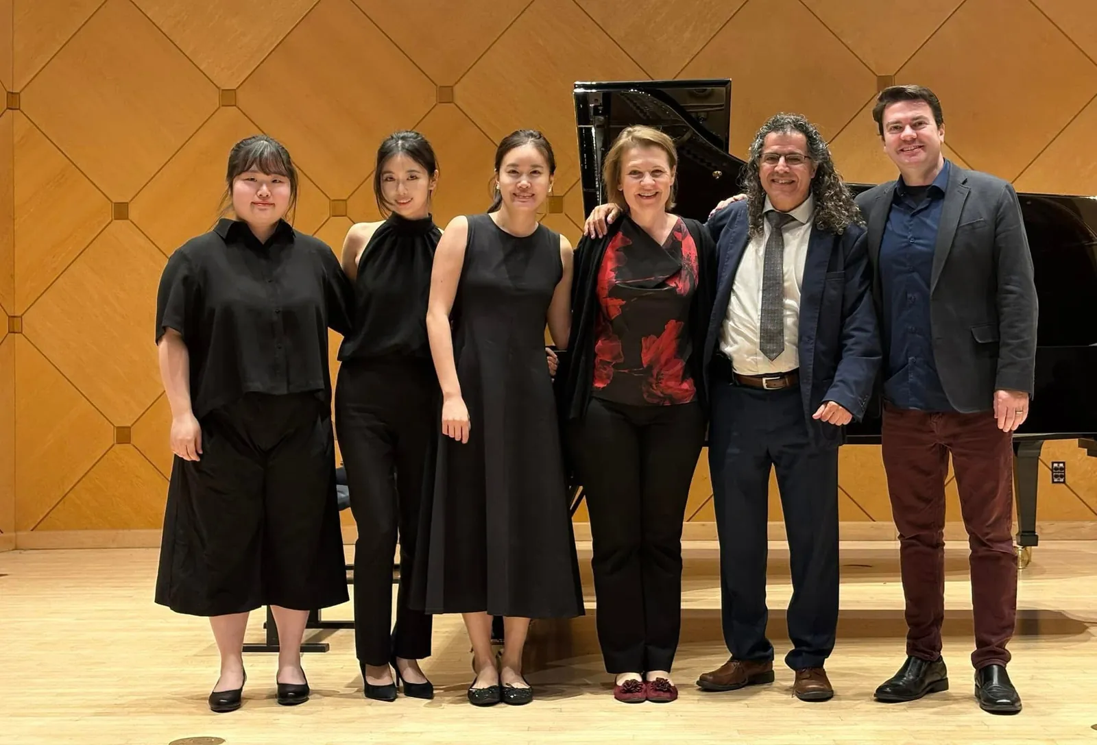 Rui Xi with musicians in a concert hall